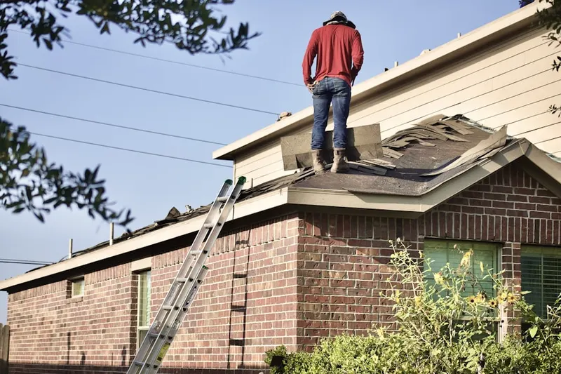 Professional roofer working on a residential roof in Rancho Huntington Mobile Home Park
